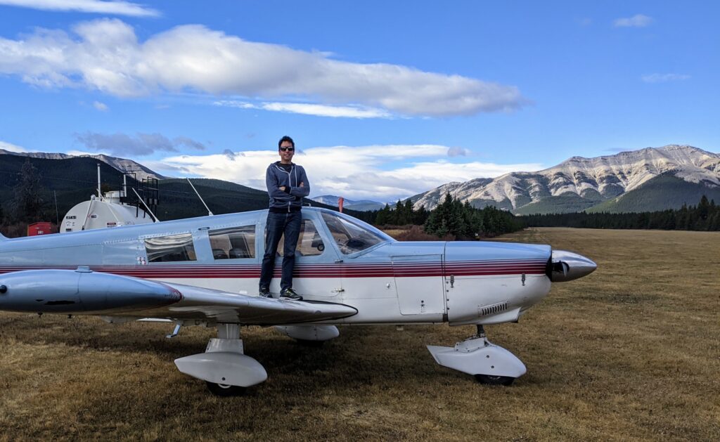 Blake standing on top of the wing of his new airplane.